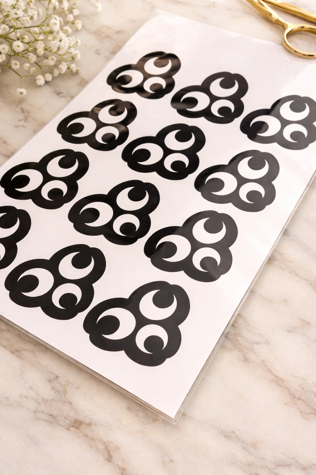 Crescent moon henna stencil sheet displayed on marble background with minimalist styling