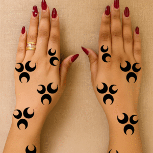 Two hands with crescent moon henna stencil design arranged in a minimal tribal pattern on fingers and wrists