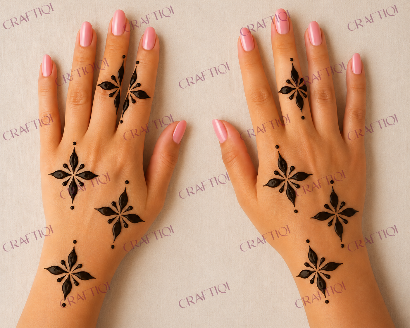 Two hands with glossy pink nails wearing simple black floral henna designs created using Craftiqi henna stencils.