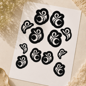 A4 henna stencil sheet with circular swirl designs in multiple sizes displayed at an angle on a soft beige background with delicate white flowers and lace accents.