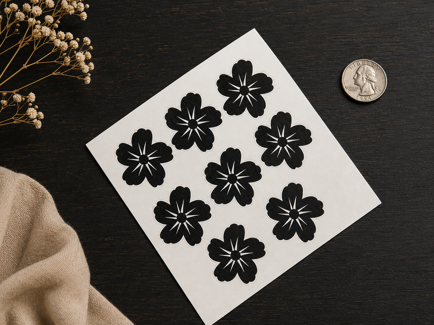 Black floral temporary henna tattoo sheet displayed on dark background